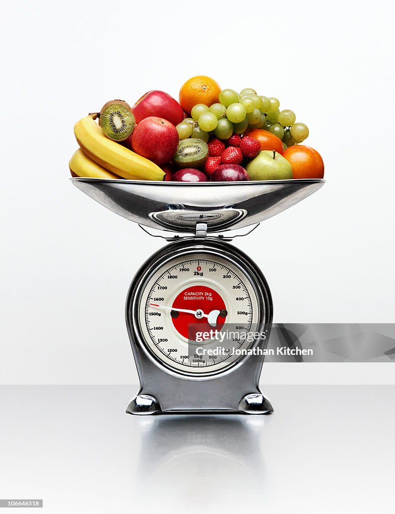A selection of fruit on a weighing scale