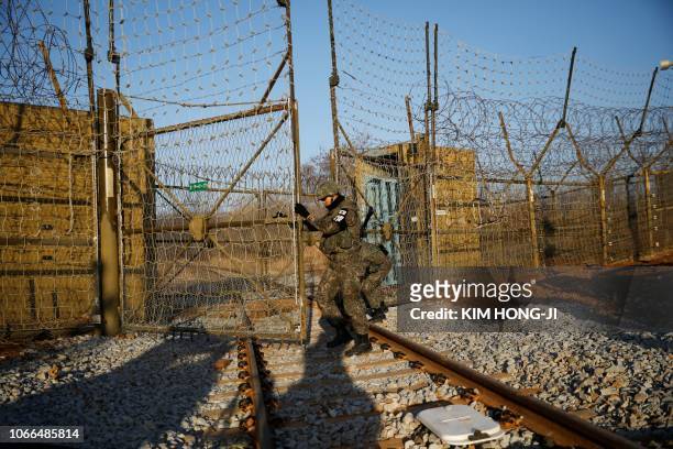 South Korean soldiers open the gate as the rails which leads to North Korea is seen, inside the demilitarized zone separating the two Koreas in Paju...