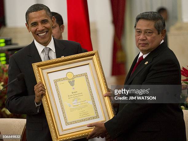 President Barack Obama recieves a letter of appreciation for his mother, Stanley Ann Dunham, from Indonesian President Susilo Bambang Yudhoyono...