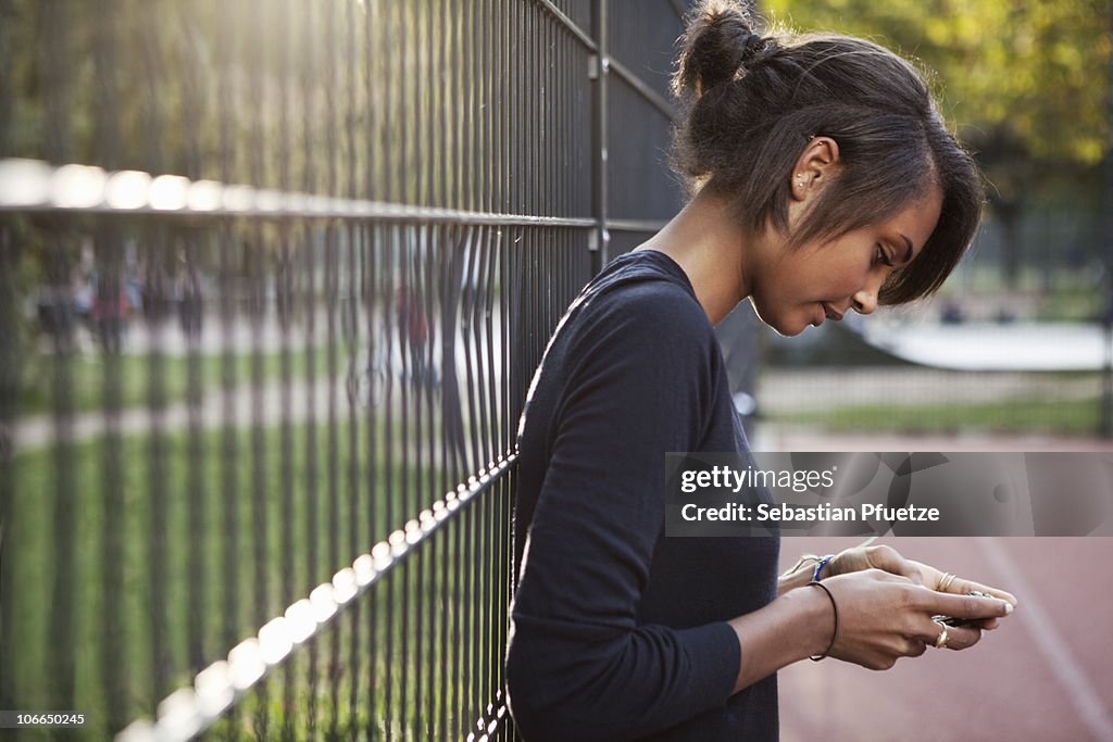 Teenage girl sending text message