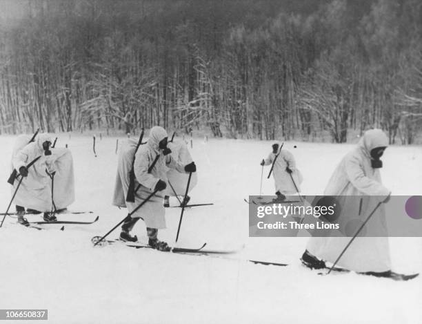 Finnish troops wearing gas masks during the Winter War between the Soviet Union and Finland, circa 1940.