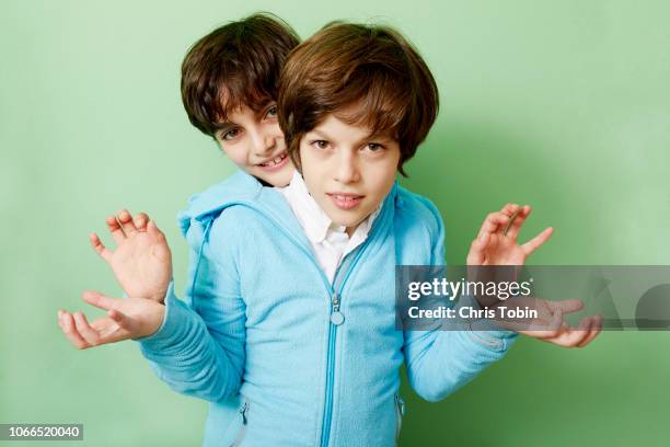 two boys stuck together in one blue hoodie with hands sticking out - conjoined twin stock pictures, royalty-free photos & images