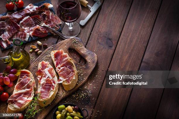 food backgrounds: preparing iberico ham sandwich/spanish bocadillo de jamon iberico - spanish food stock pictures, royalty-free photos & images