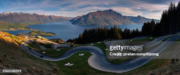 panorama of luge track in queenstown skyline - luge stock pictures, royalty-free photos & images