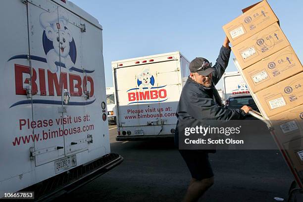 Gerardo Garcia unloads a Bimbo delivery truck at one of the company's bakeries on November 9, 2010 in Bedford Park, Illinois. Today it was announced...