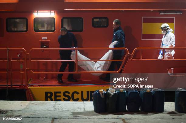 Corpse of a migrant woman is carried from rescue vessel toward a mortuary van after her arrival at the Port of Malaga. Spains Maritime Rescue service...