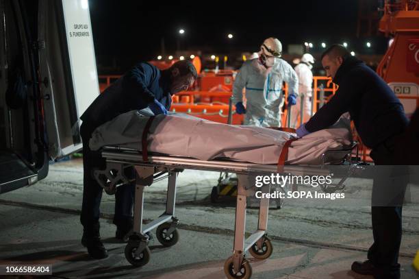 Corpse of a migrant woman is carried into a mortuary van after her arrival at the Port of Malaga. Spains Maritime Rescue service rescued 237 migrants...