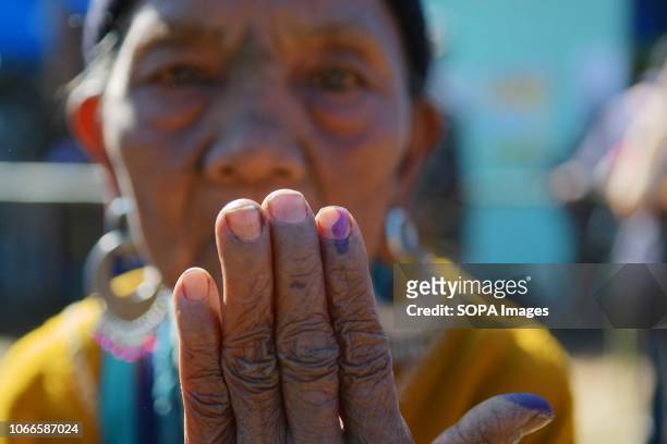 Bru refugee seen showing off her ink mark after casting her vote at the Kanhmun. Bru refugees cast their votes in a special polling center set up for...