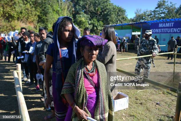 Bru refugees are seen standing in a queue as they wait to cast their votes during the elections. Bru refugees cast their votes in a special polling...