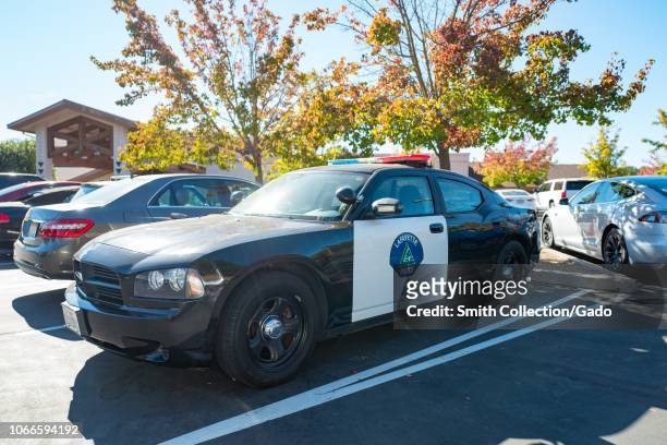 Lafayette Police vehicle parked outside the Temple Isaiah synagogue in Lafayette, California, providing a police presence during Saturday morning...