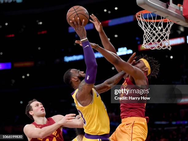 LeBron James of the Los Angeles Lakers scores as he is fouled by Myles Turner of the Indiana Pacers in front of Bojan Bogdanovic during a 104-96...