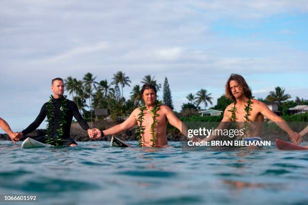 South Africa's surfer Grant Twiggy Baker, Hawaii's surfer Reef Mcintosh and Hawaii's surfer Danny Fuller attend the opening ceremony of the 2018...