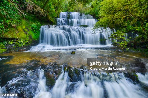 the famous purakaunui waterfall in the catlins on the southern scenic route. purakaunui river, purakaunui falls, the catlins, otago, south island, new zealand, australasia, oceania. - timelapse new zealand stock pictures, royalty-free photos & images