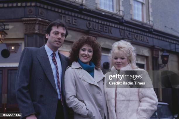 Actors Leslie Grantham, Anita Dobson and Letitia Dean pictured on the exterior set of the BBC soap opera 'EastEnders', January 10th 1985.