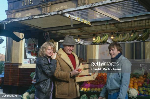 Actors Gillian Taylforth, Peter Dean and Adam Woodyatt pictured on the exterior set of the BBC soap opera 'EastEnders', November 21st 1984.