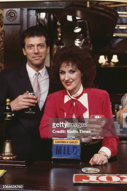 Actors Leslie Grantham and Anita Dobson pictured on the Queen Victoria pub set of the BBC soap opera 'EastEnders', December 18th 1985.