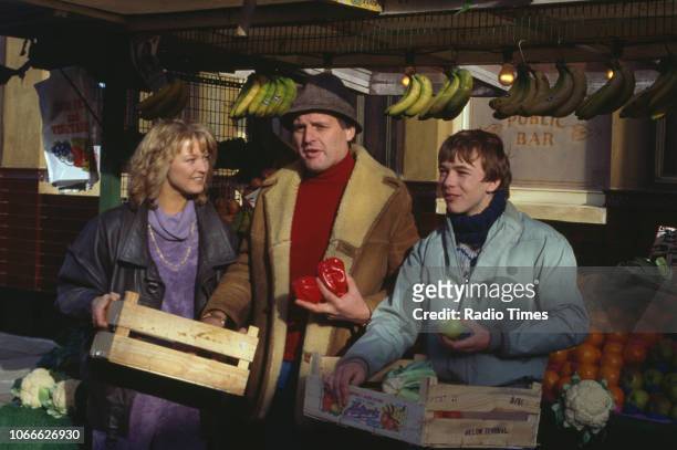 Actors Gillian Taylforth, Peter Dean and Adam Woodyatt pictured on the exterior set of the BBC soap opera 'EastEnders', September 26th 1986.
