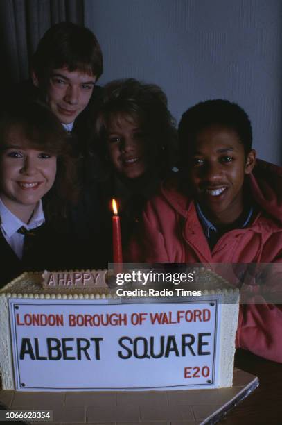 Actors Susan Tully, Adam Woodyatt, Letitia Dean and Paul J Medford pictured with a celebration cake on the set of the BBC soap opera 'EastEnders',...