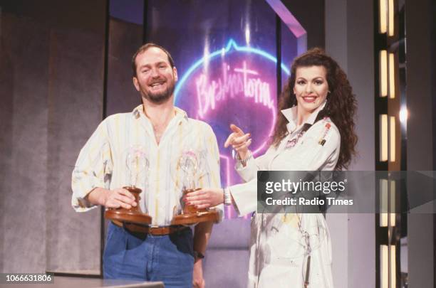 Presenters Kenny Everett and Cleo Rocos pictured on the set of the BBC television show 'Brainstorm', December 23rd 1987.