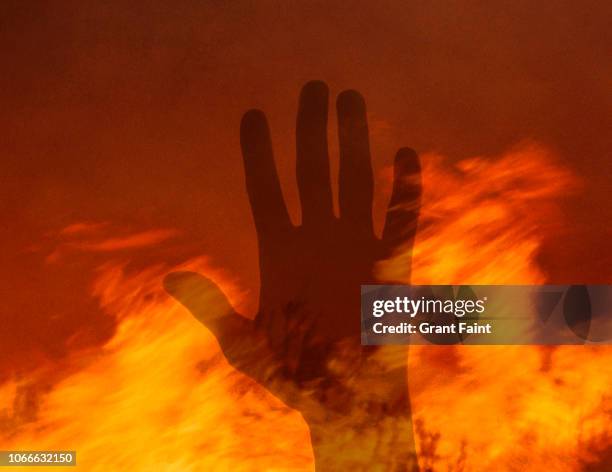 single male hand in fire. - hate crime stock pictures, royalty-free photos & images