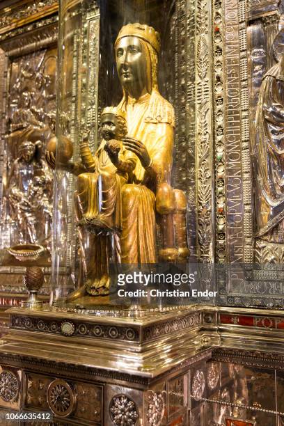 The black madonna of Montserrat . The figure ist carved out of paple wood and is, except for the head and hands, set in gold. In her right hand she...