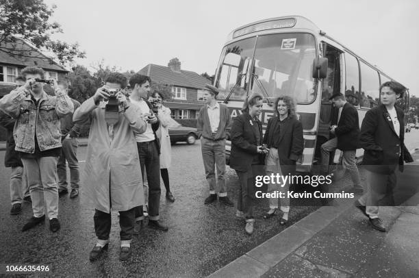 Fans of English pop group The Smiths take pictures of the house at 384 King's Road, Stretford, Greater Manchester, where Smiths frontman Morrissey...