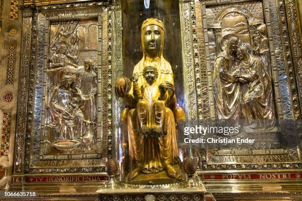 The black madonna of Montserrat . The figure ist carved out of paple wood and is, except for the head and hands, set in gold. In her right hand she...