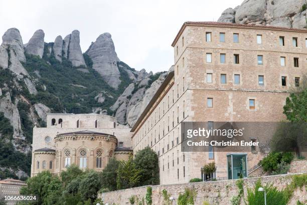 Abbey of the Order of Saint Benedict located on the mountain of Montserrat in Monistrol de Montserrat, Catalonia, Spain, in the background parts of...