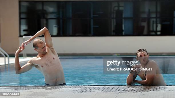 New Zealand cricketers Brendon McCullum and Chris Martin relax in a swimming pool after a training session at The Rajiv Gandhi International Cricket...