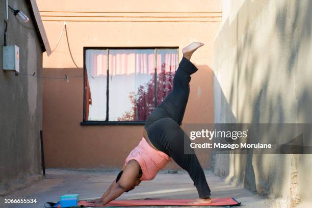 woman practising yoga - showus africa stock pictures, royalty-free photos & images