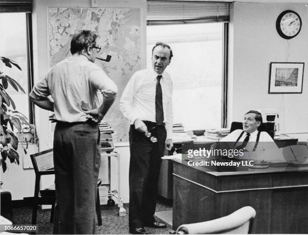 Rupert Murdoch, , in the editors' office with Bruce Rothwell, assistant to Publisher Murdoch, and Editor Roger Wood confer on getting the New York...