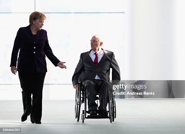 German Chancellor Angela Merkel and German Finance Minister Wolfgang Schaeuble arrive for a press conference at the Chancellery on November 10, 2010...