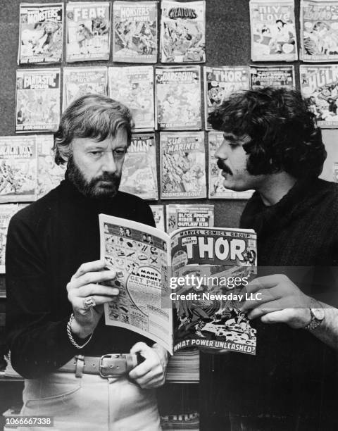 Stan Lee reads a comic book with Steve Lemberg at their office on Madison Avenue in Manhattan, New York on November 5, 1971 while working on adapting...