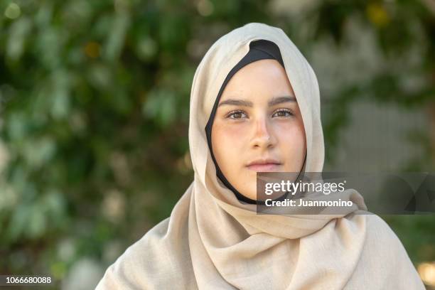 serious young muslim woman looking at the camera - teenager serious stock pictures, royalty-free photos & images