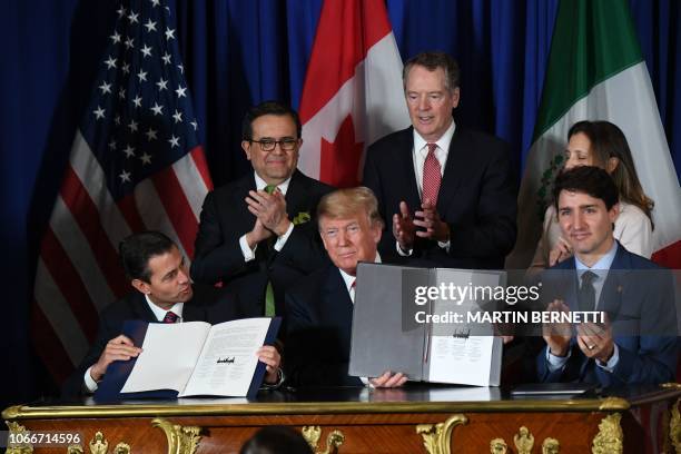 Mexico's President Enrique Pena Nieto US President Donald Trump and Canadian Prime Minister Justin Trudeau, are pictured after signing a new free...