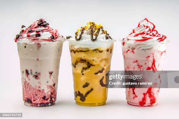 glass of frappe milkshake with milk and cherry fruit - malt stockfoto's en -beelden