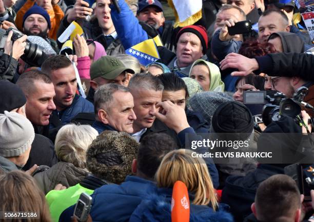 War time commander of Bosnian Muslim fighters in Srebrenica, Naser Oric is ingulfed by supporters as he leaves Court of Bosnia and Herzegovina, in...