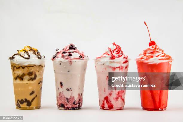 glass of frappe milkshake with milk and cherry fruit - coffee frappe stock-fotos und bilder