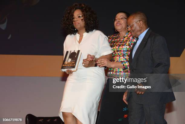 Oprah Winfrey receive a he Prison Letters of Nelson Mandela book from Graça Machel and Professor Njabulo Ndebele during the Nelson Mandela...