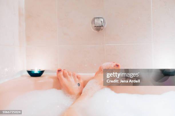 bubble bath first person perspective, woman's feet in bubble bath, woman in bath tub, bubble bath, indulgence, bubbles, tub, bath first person perspective - woman bath bubbles stock pictures, royalty-free photos & images