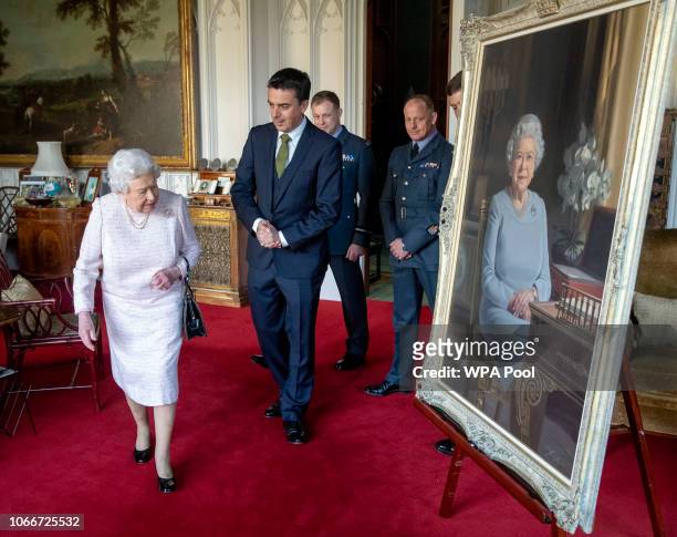 Queen Elizabeth II, accompanied by artist Stuart Brown, Air Commodore Scott Miller, Deputy Commandant of The Defence Academy of the United Kingdom,...