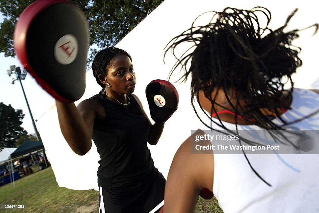 Dc-cover10 08-01-2006 #182624 Mark Gail_TWP Boxer Lisa "Too Fierce" Foster spars with her daughter T