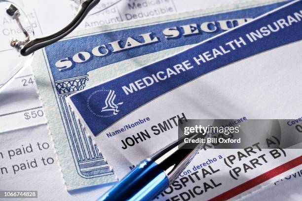 medicare health insurance and social security card on medical report docuement - government check stock pictures, royalty-free photos & images