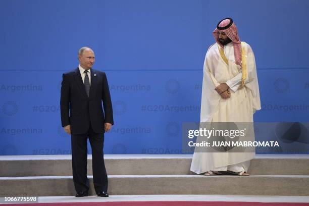 Russia's President Vladimir Putin and Saudi Arabia's Crown Prince Mohammed bin Salman line up for a family photo, during the G20 Leaders' Summit in...