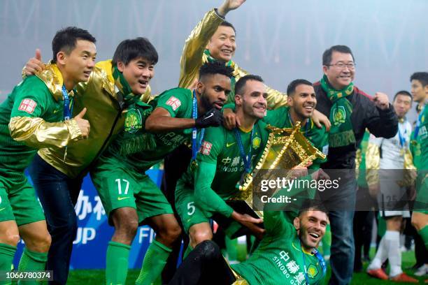 Beijing Guoan players celebrate after winning the Chinese FA Cup final after drawing 2-2 in the second leg with Shandong Luneng in Jinan, in China's...