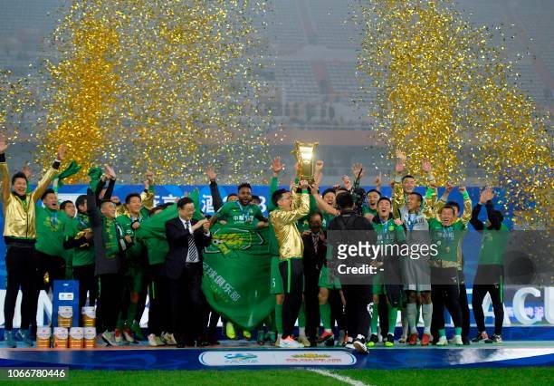 Beijing Guoan players celebrate after winning the Chinese FA Cup final after drawing 2-2 in the second leg with Shandong Luneng in Jinan, in China's...
