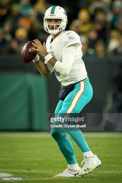 Brock Osweiler of the Miami Dolphins drops back to pass in the second quarter against the Green Bay Packers at Lambeau Field on November 11, 2018 in...