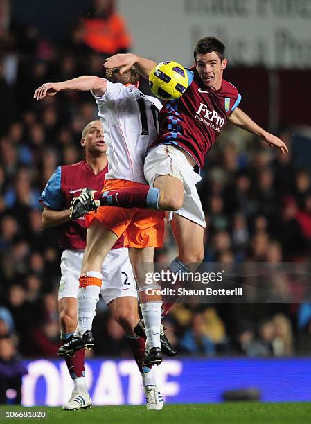 Ciaran Clark of Aston Villa challenges Brett Ormerod of Blackpool during the Barclays Premier League match between Aston Villa and Blackpool at Villa...