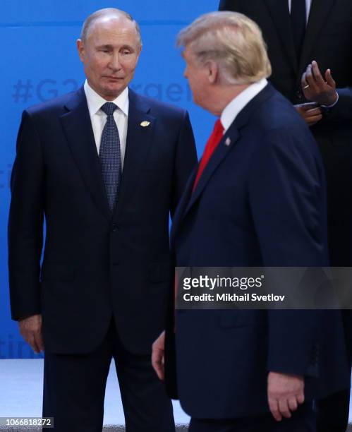 Russian President Vladimir Putin looks at U.S. President Donald Trump during the welcoming ceremony prior to the G20 Summit's Plenary Meeting on...