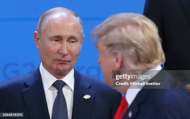 Russian President Vladimir Putin looks at U.S. President Donald Trump during the welcoming ceremony prior to the G20 Summit's Plenary Meeting on...